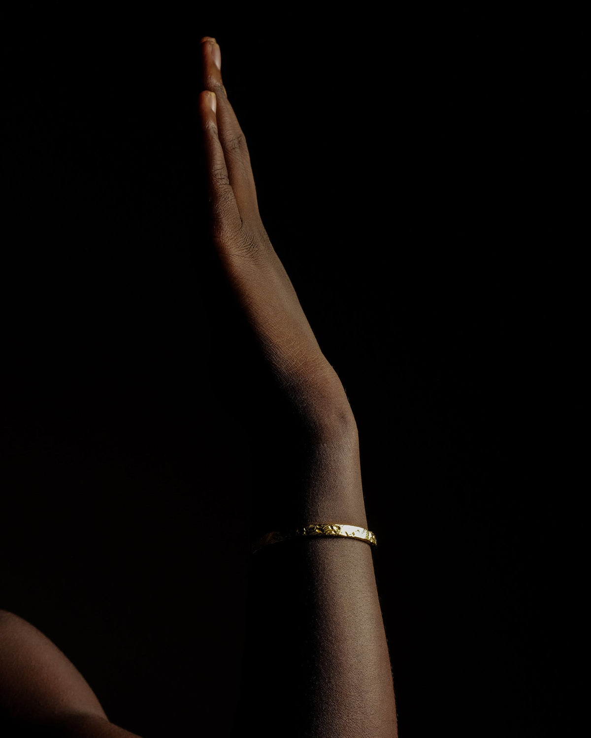 Mickey cuff bracelet worn on a model's wrist